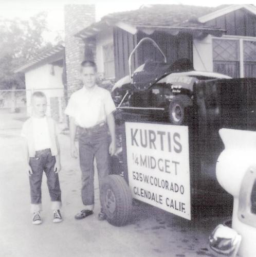 “Jack (left) and brother Dean standing beside the tandem trailer the family used to tour the country with the “Hot Dog Jack” and the “Buzz Bomb.”